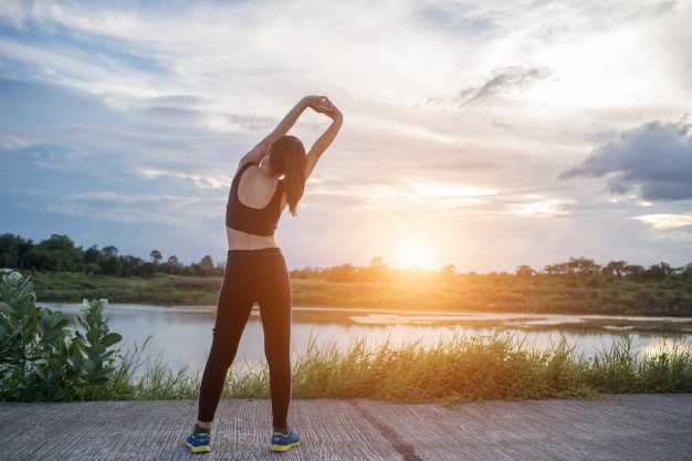 7f8df-healthy-young-woman-warming-up-outdoors-workout-before-training-session-park_1150-4186